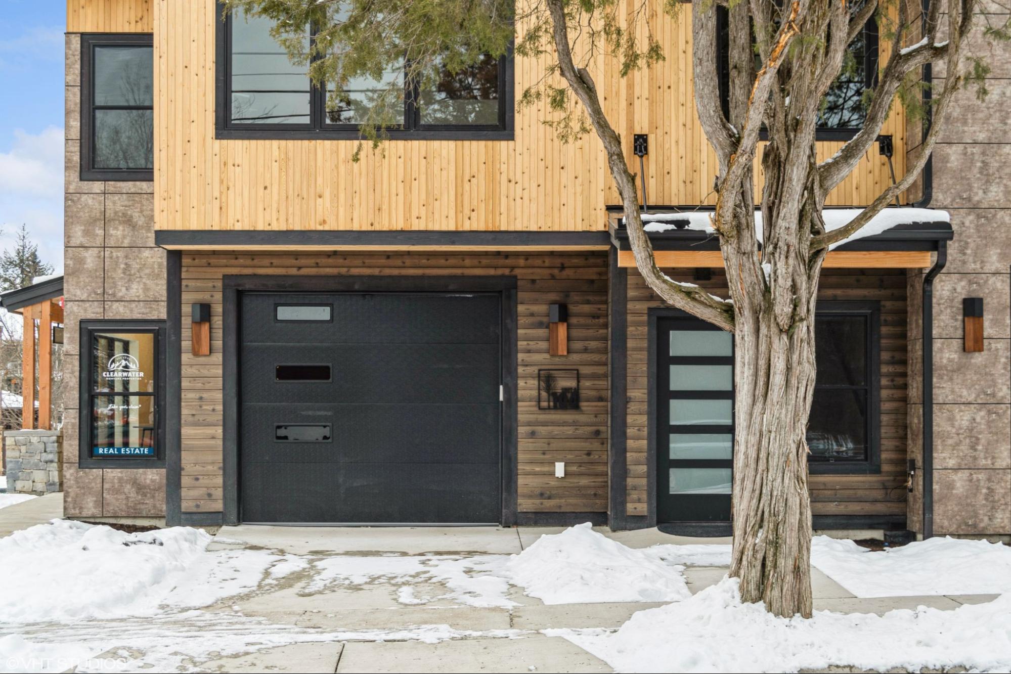 This image shows a modern wooden house exterior featuring elegant wood siding, blending seamlessly with minimalist architectural features.