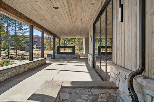 A church exterior features an overhang with elegant tongue and groove planks & matching wall. 