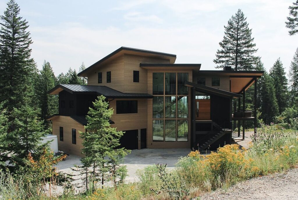 Replacing wood siding on a luxury multi-story home brings a bold contrast against the black trim