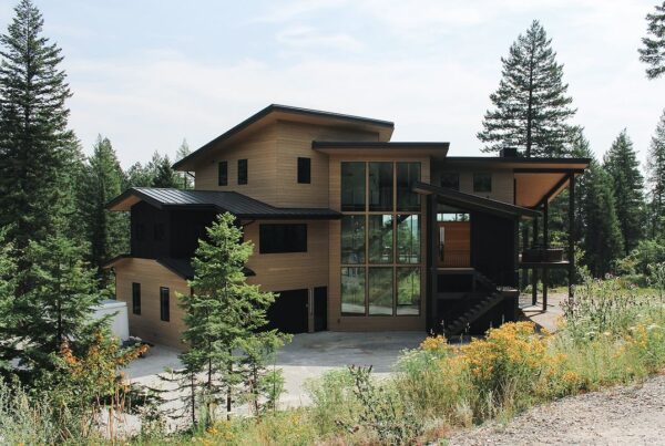 Replacing wood siding on a luxury multi-story home brings a bold contrast against the black trim
